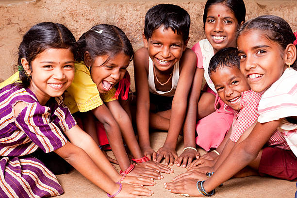 Home group of cheerful rural indian children playing in a village in maharashtra